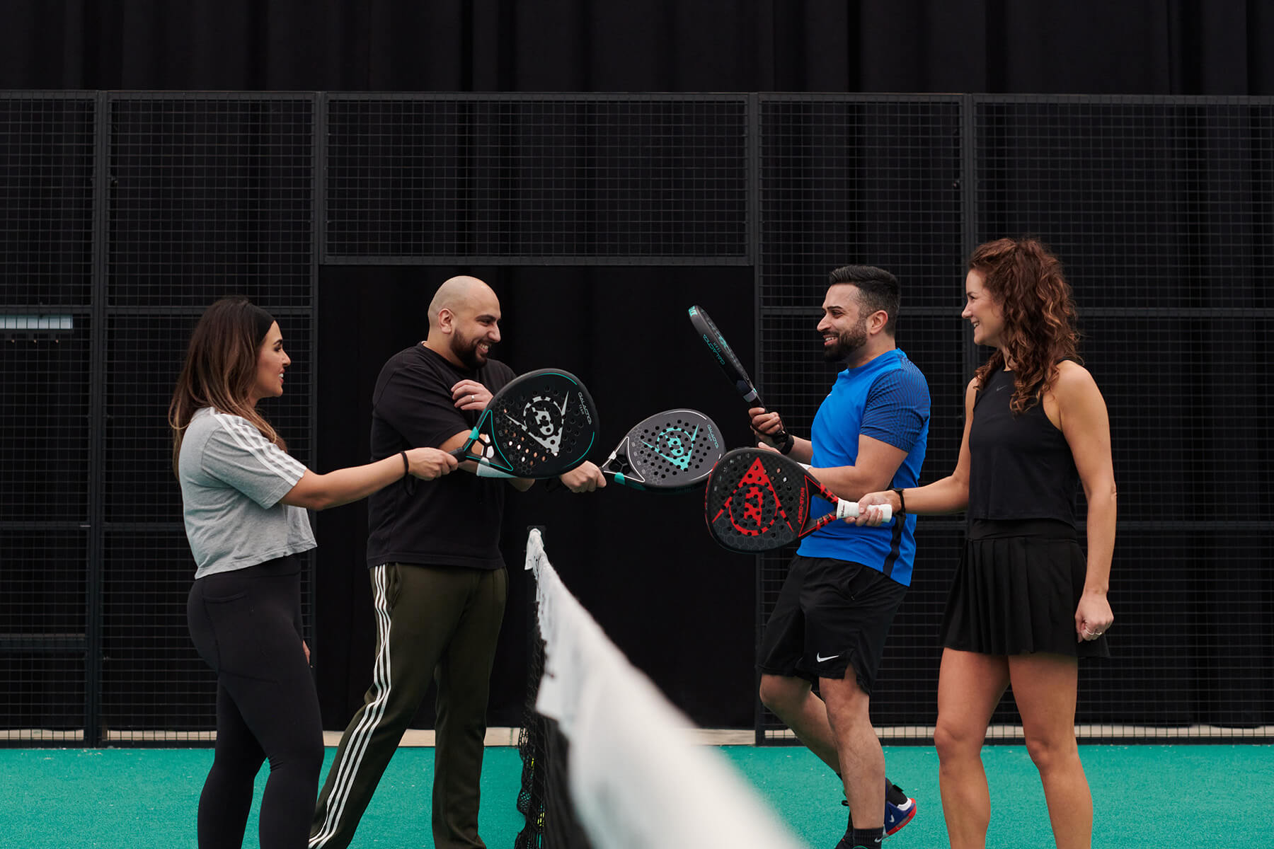 player-tapping-rackets-at-net.jpg